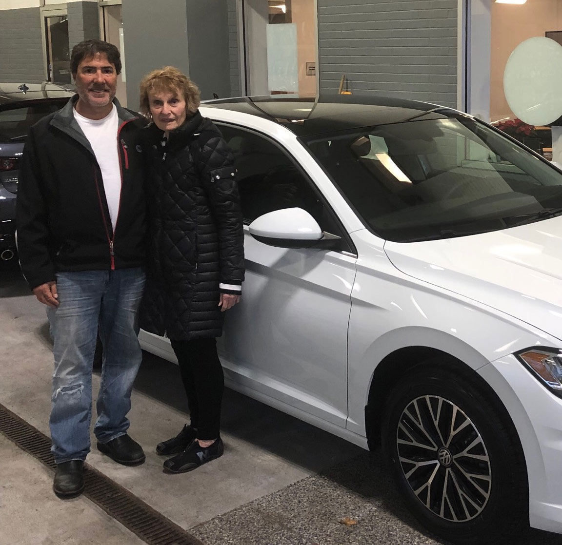 Michael standing with Harriet from University Heights and her new luxury vehicle.